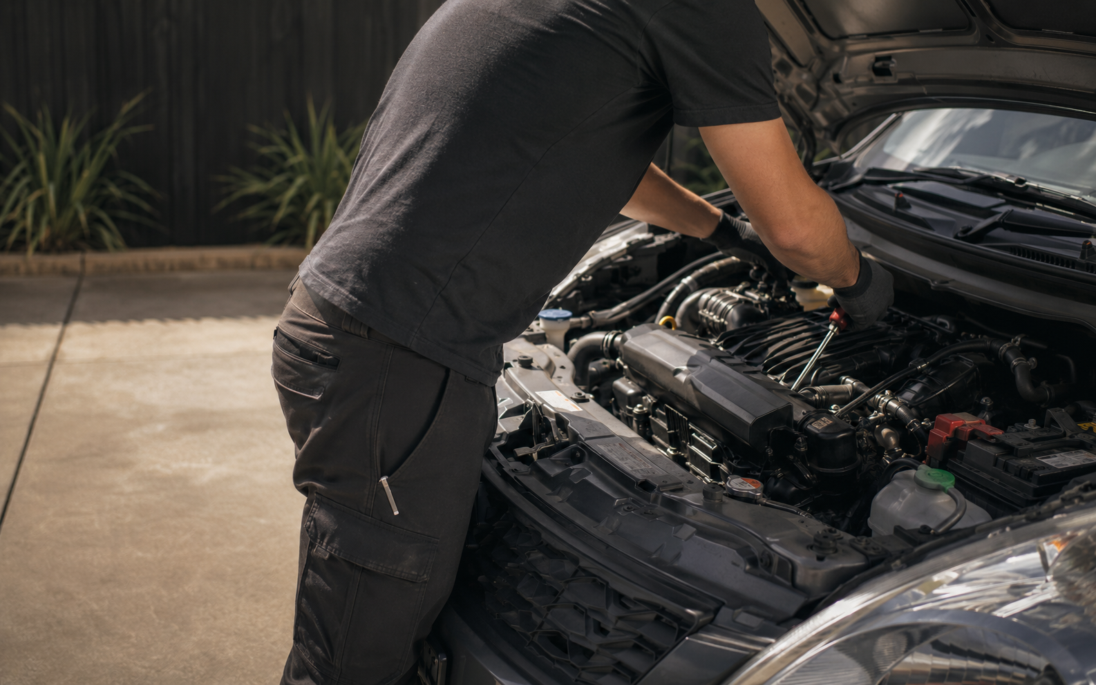 Mobile mechanic working on a vehicle at a customer location